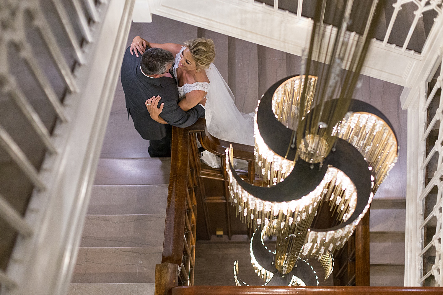 Brass on Baltimore Wedding Photos of couple only with stairwell and chandelier