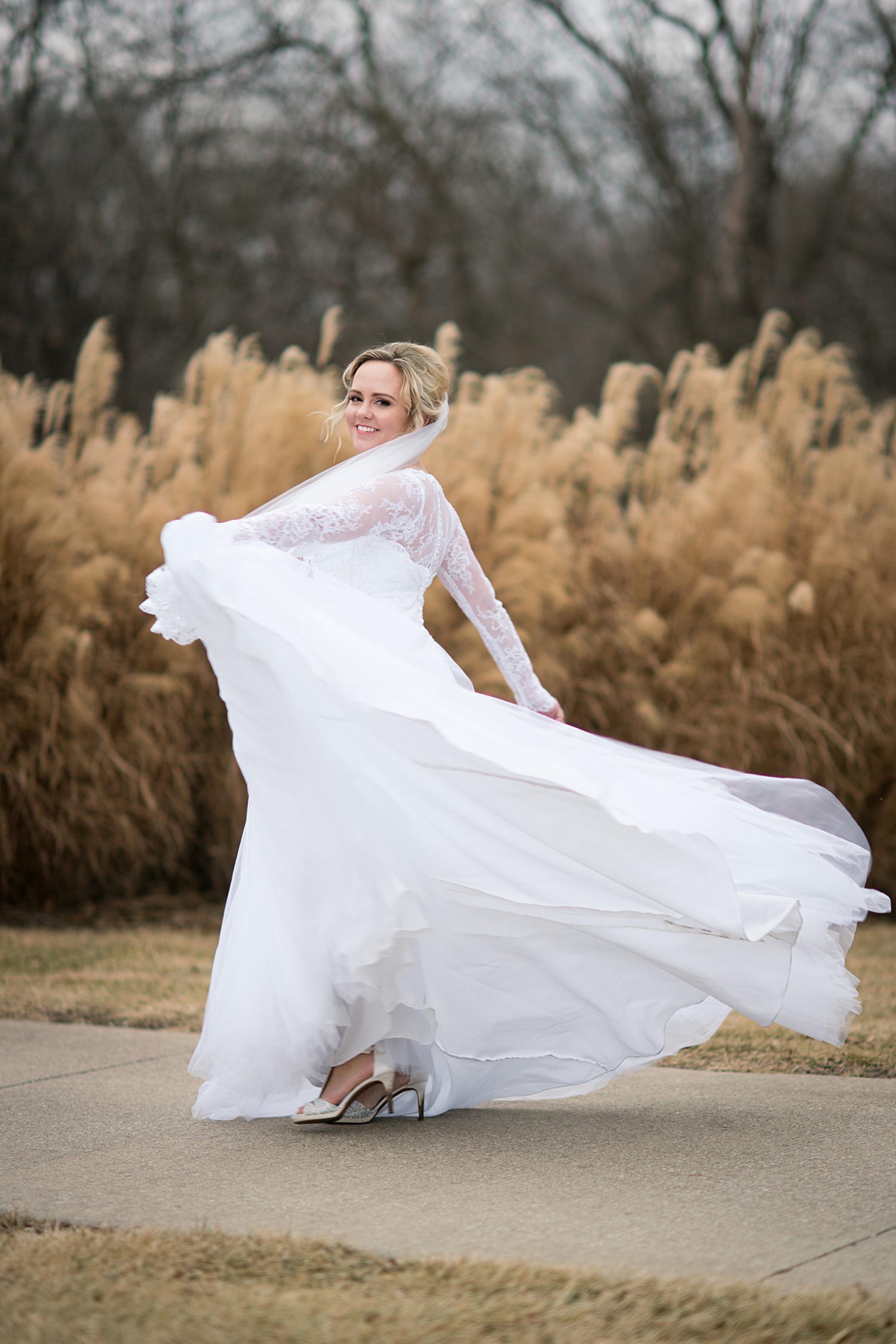 Bride twirling dress Photos Outside at St-Andrews-Golf-Course-Wedding-Photos-Overland-Park-KS-Wedding-Photographer-Emily-Lynn-Photography