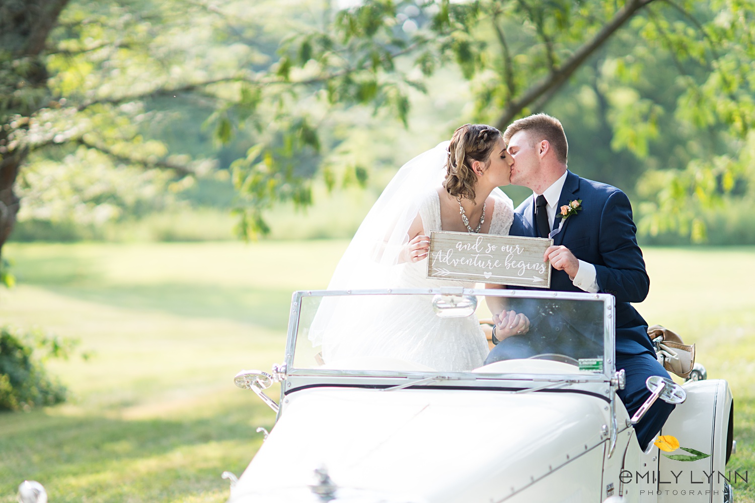 Wedding couple's photo in old car. Wedding-Photos-at-Enchanted-Acres-KC-Wedding-Photographer-Emily-Lynn-Photography.