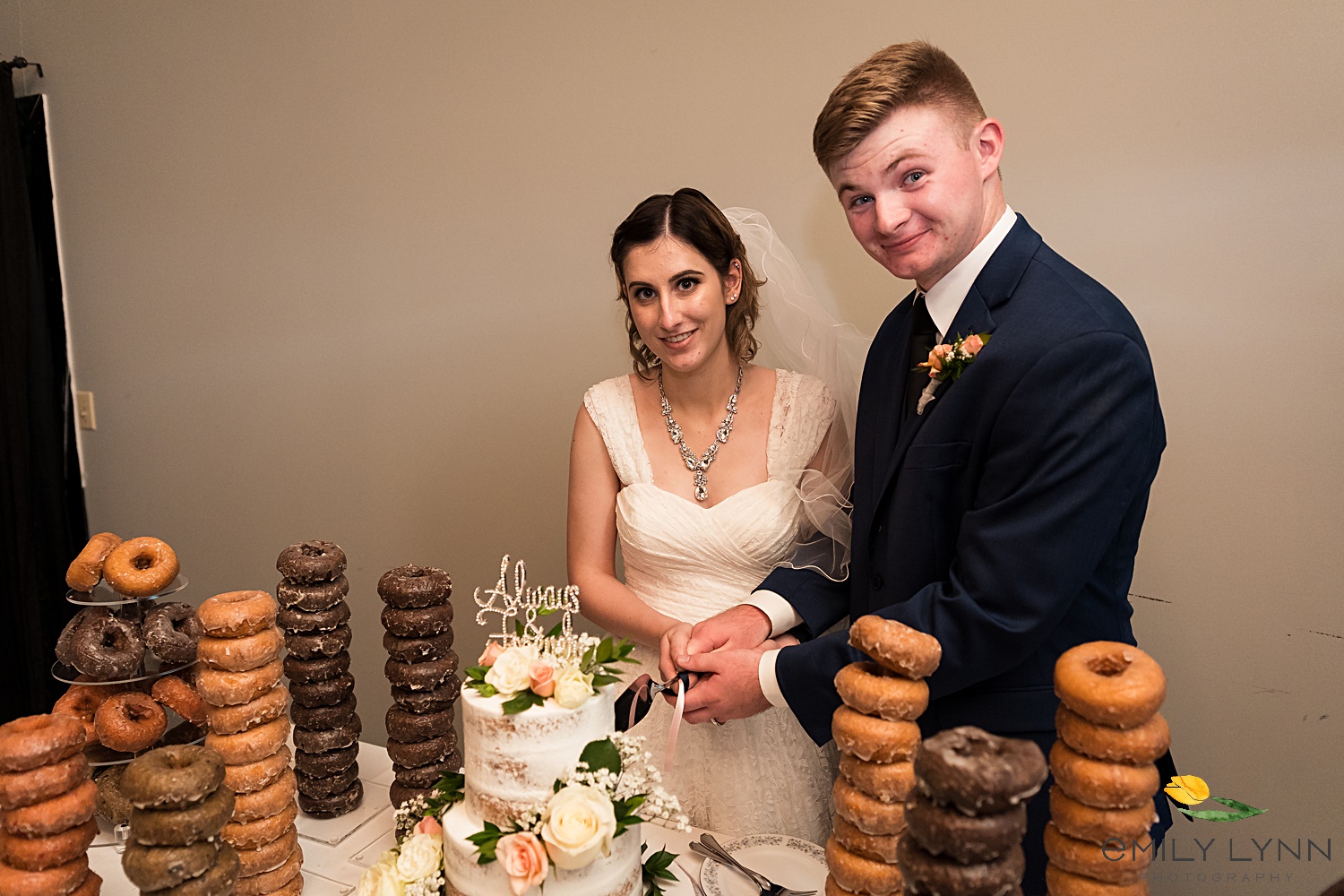 Cake cutting photo. Wedding-Photos-at-Enchanted-Acres-KC-Wedding-Photographer-Emily-Lynn-Photography.