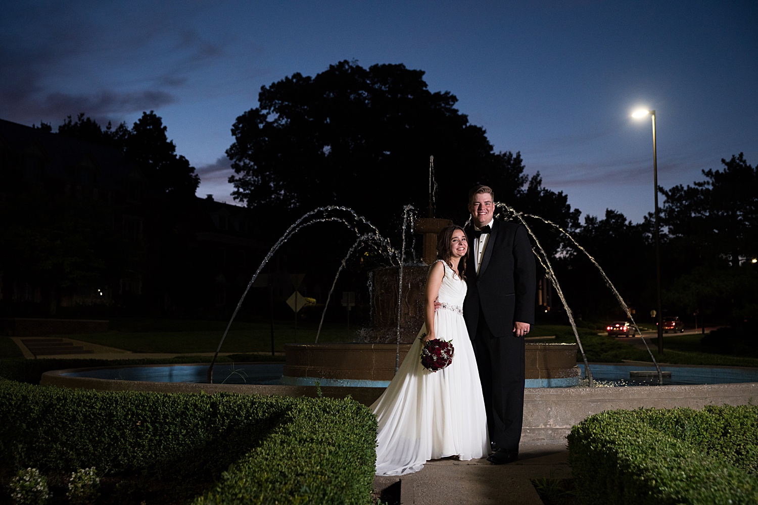 Wedding photo in front of fountain at KU's campus.